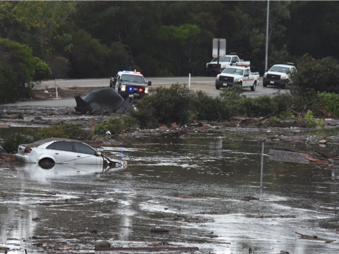 Some cars were left floating along flooded freeways, while emergency services did their best to get to affected areas.