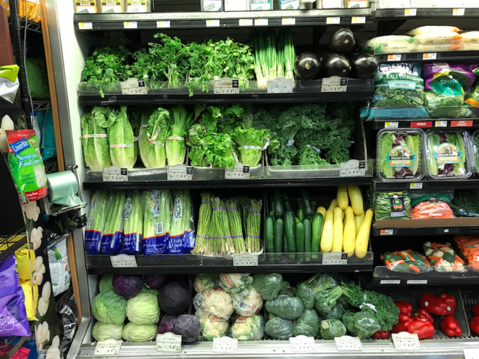 We find the fresh vegetable section tucked towards the back of the store. Glowing green, these unpackaged products look very fresh.