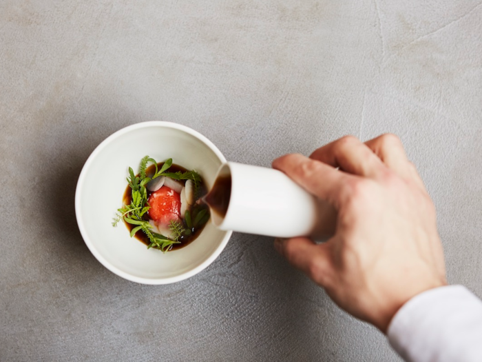 Artichoke broth with smoked yolk and winter leaves at L