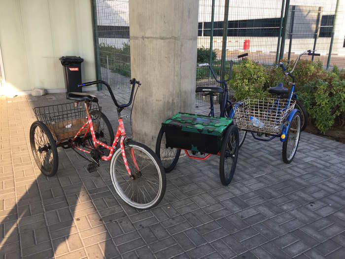 To get around the complex, workers use tricycles like these.