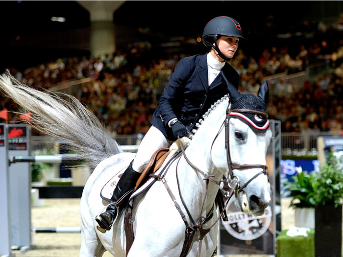 Show jumping uniforms consist of jackets, boots, breeches, jodhpurs, and a protective helmet.