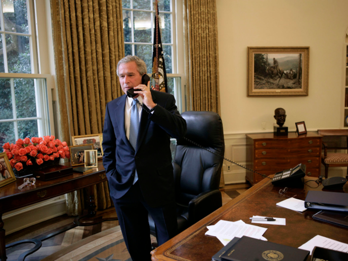 George W. Bush also displayed family photos, along with a bouquet of flowers, in this 2004 photo.