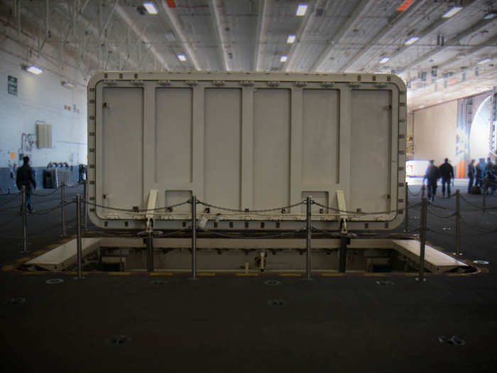 This is one of the advanced weapons elevators, which connect to the flight deck, and allows sailors to easily move ordnance from the magazines to the aircrafts.