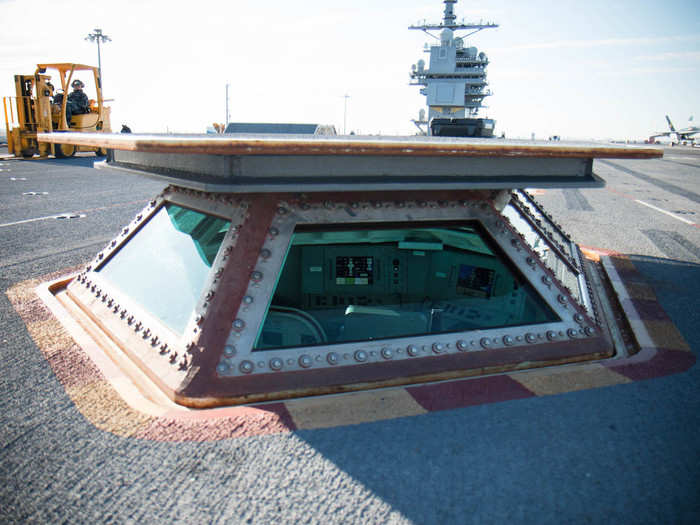 This compartment, which can be raised and lowered, is called the Integrated Catapult Control System or "bubble." Officers in here launch the jets after getting the all clear from the signalmen.