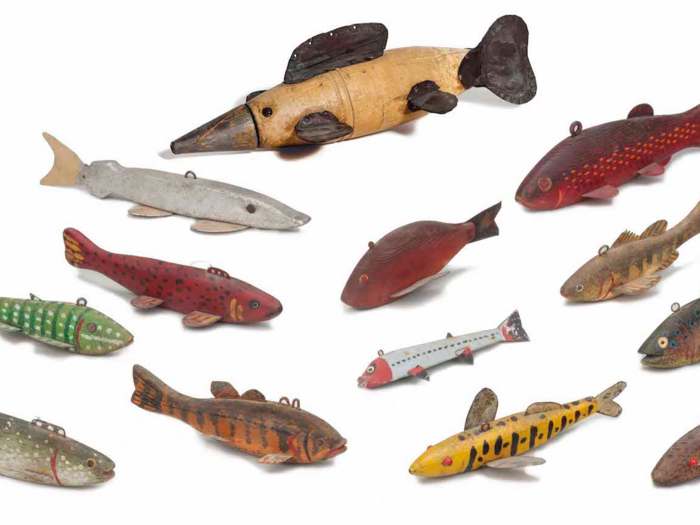 A dozen wooden fish decoys