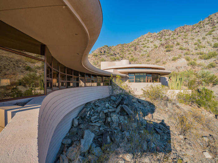 Built on the side of a cliff, the concrete home fits seamlessly into the desert landscape and serves as a testament to Lloyd