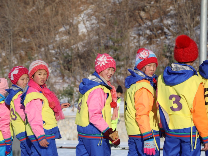 Young skiers prepare to be pulled to the top of the bunny slope.