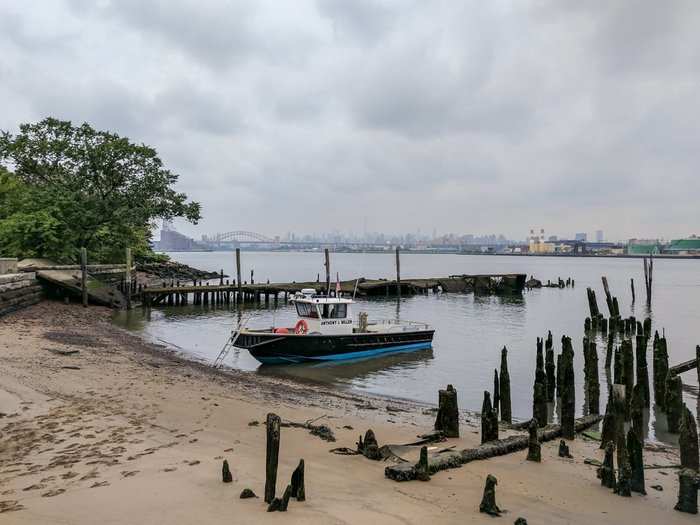 The arc-shaped Hell Gate Bridge on the East River is visible from North Brother