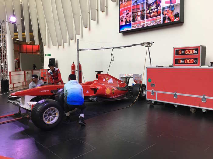 In addition to the traditional rides, Ferrari World also features interactive experiences like the pit lane challenge where park goers race one another to see who can change a tire in the shortest amount of time.