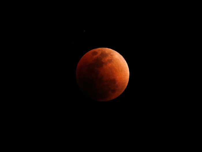 The reddish color the moon takes on happens because of the way Earth