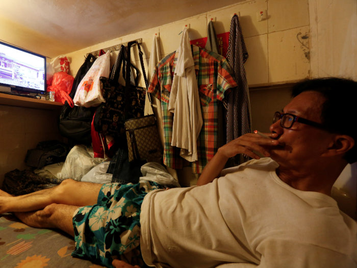 Simon Wong, a 62-year-old resident, has just enough room to hang a few shirts and pairs of pants. His rent of $226 would be enough to share a small one-bedroom apartment in some American towns.