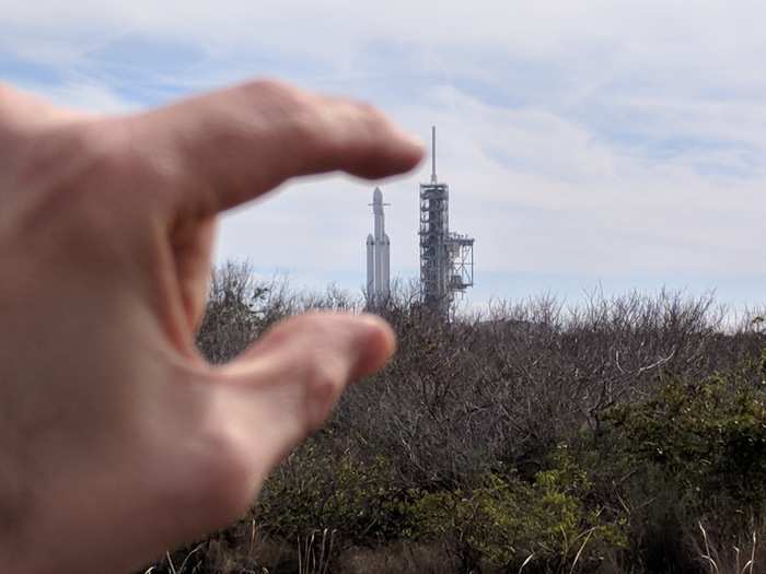 At first, Falcon Heavy — which is 230 feet tall — looked tiny in the distance.