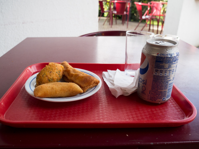 This is what a typical snack looks like in Brazil: deep fried savoury "salgados" with a fizzy drink. Brazilians love to snack all day long, especially on the beach. There are some very specific rules about how you consume these items, though.