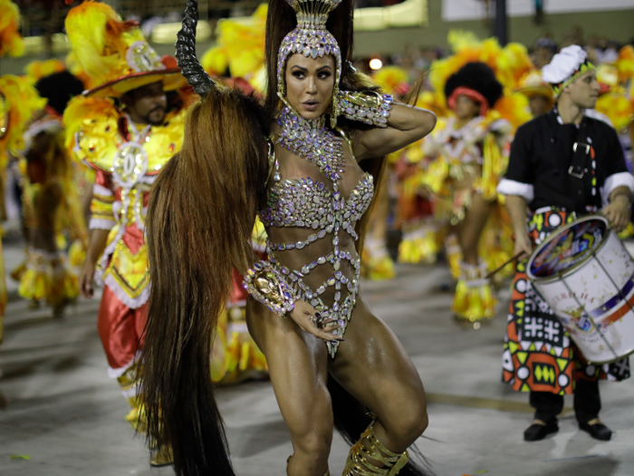 Each school has a "drum queen" who dances non-stop to the rhythm of hundreds of drummers.