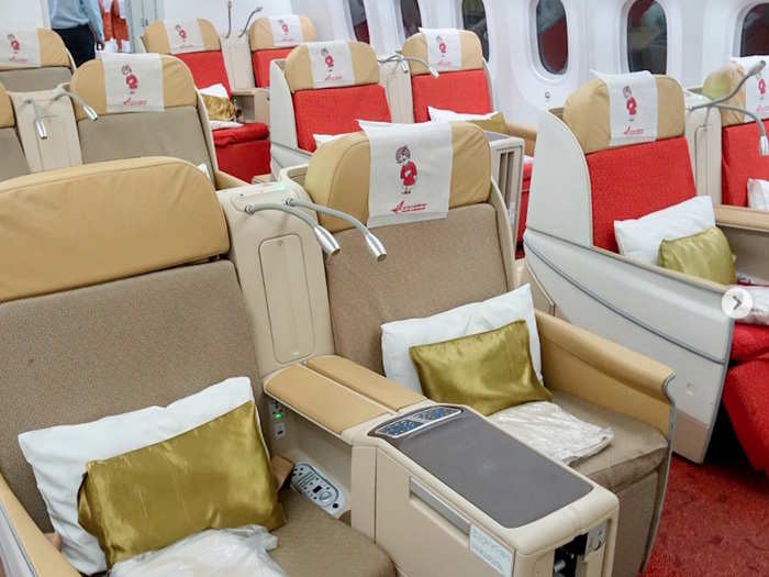 On board, the colour scheme may be garish — but Air India’s 787 business class cabin is fully equipped with lie-flat seats.