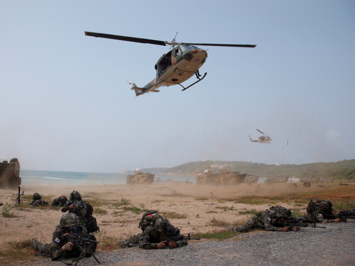 As Marines gain ground, helicopters fly in more troops beyond the shoreline to surround any enemy defenders and to provide cover for those on the beach.