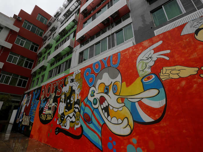 The exteriors of the youth apartments are decorated in ways that appeal to young customers, as this graffiti wall shows.