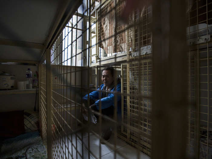 In Hong Kong, skyrocketing property values force some residents to live in cheap "cage apartments." This man told a Reuters photographer he spends $230 a month on a space that consists of little more than a bed and a rice cooker.