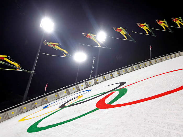 Japanese ski jumper Junshiro Kobayashi shows precision in the placement of his skis as he flies through the air in the large downhill ski jump.