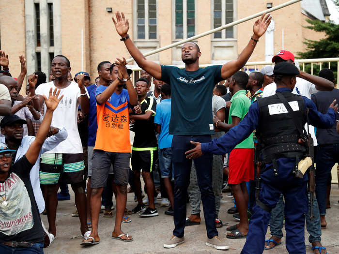 As police confined them, many churchgoers prayed and chanted slogans.