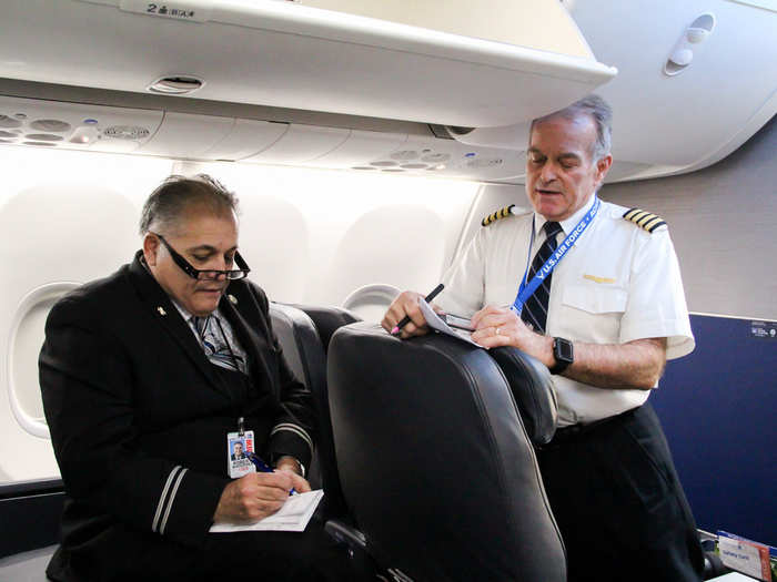 Once Bingochea and his fellow crew members have boarded the plane and stowed their baggage, they take part in the pre-flight briefing.