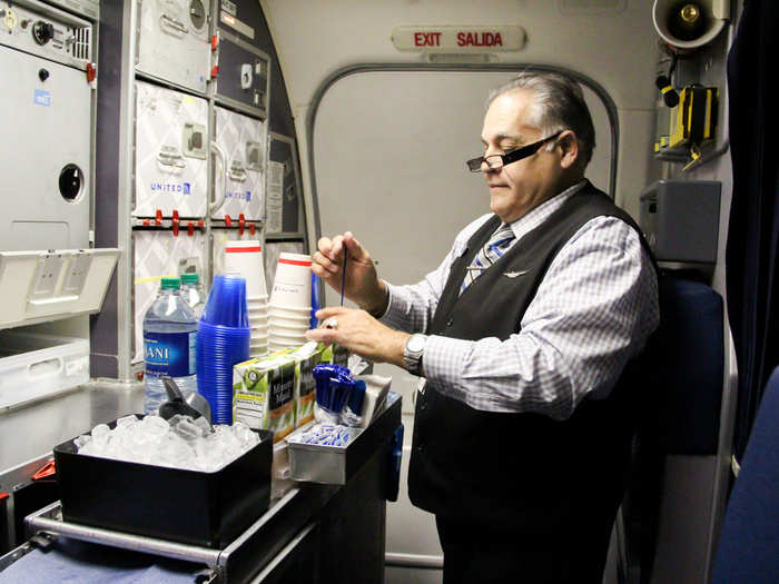 As the plane levels off, Bingochea and Kristine prepare the beverage cart, shuffling around each other and the bar cart in the tiny box that is the galley.