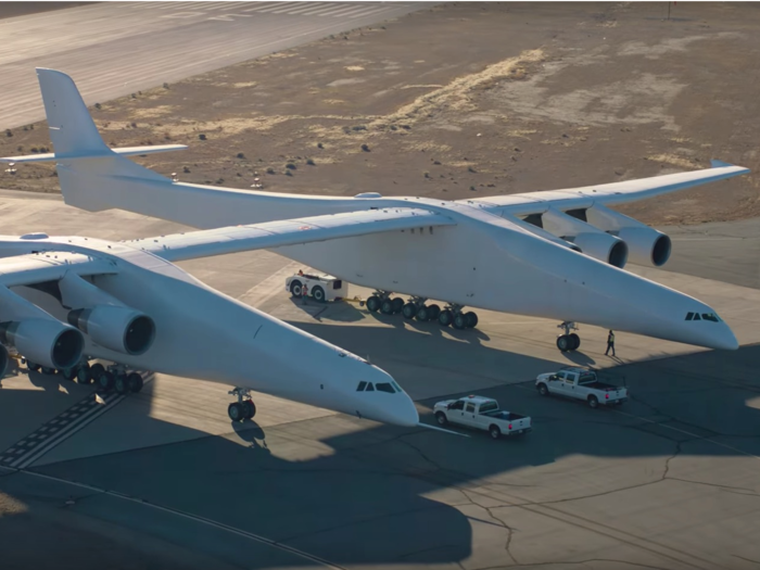 The aircraft is 238 feet long, 50 feet tall, and has six high-bypass-ratio turbofan engines.