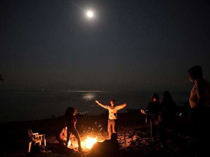 At night, people come together lighting bonfires.