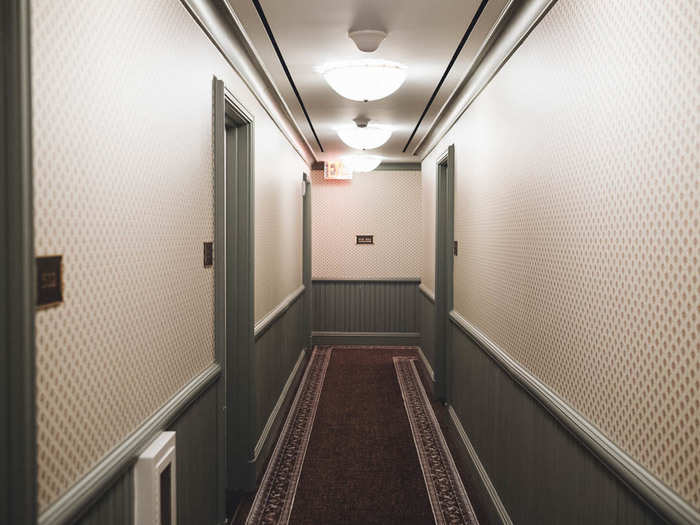 Back downstairs, this green wainscoting and patterned wallpaper in the guest room lobby wasn