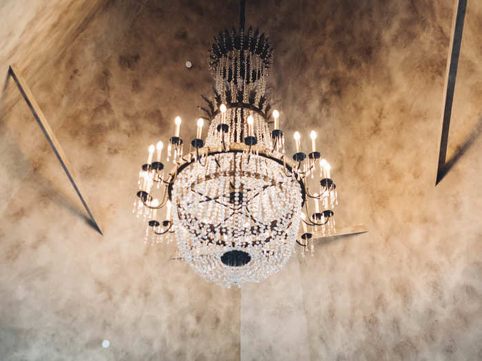 The ceiling is 40 feet high and has this sparkling chandelier hanging from its apex.