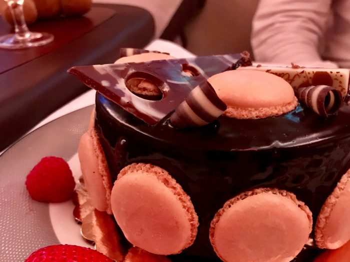 For dessert, the Millers shared a chocolate cake with macarons, chocolate tuiles, strawberries, and raspberries. The cabin crew stored their leftovers in a refrigerator so the couple could finish it later in the flight.