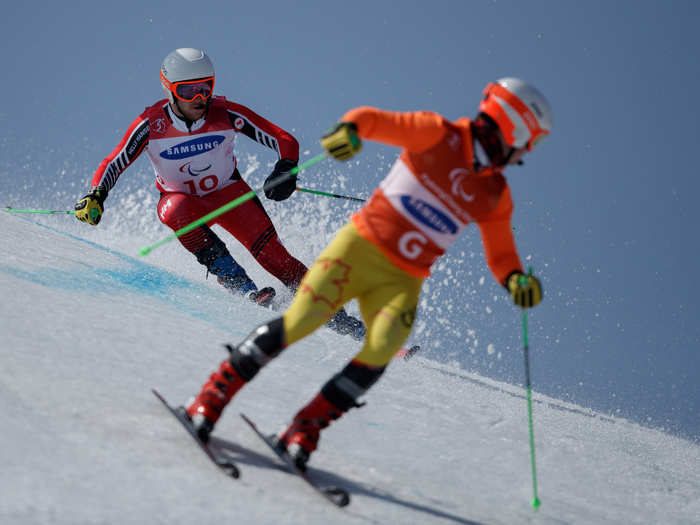 Visually-impaired skiers are accompanied by guides who chaperone them down the mountain at a great pace.