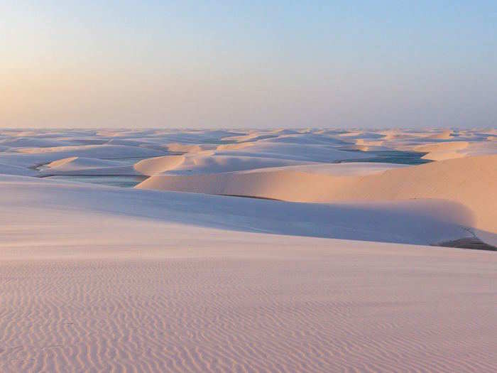 Check out the white sand dunes and rainwater lagoons at Parque Nacional Dos Lençóis Maranhenses, Brazil.