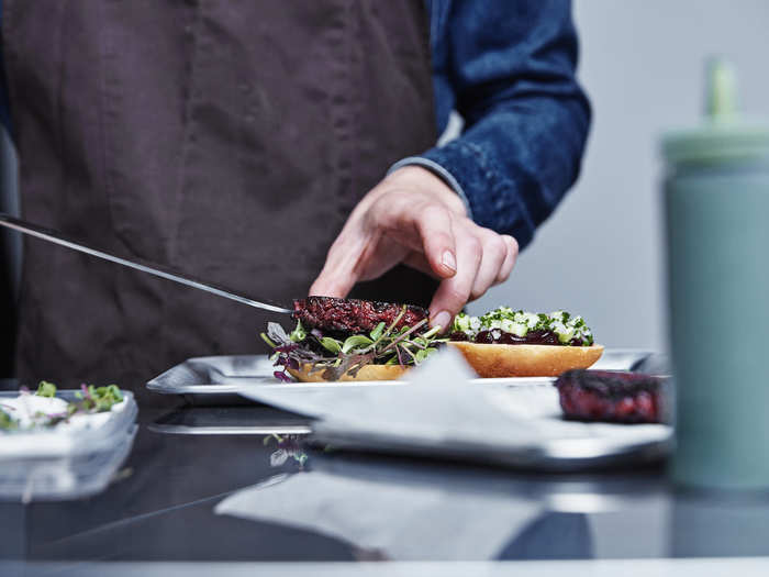 Each Bug Burger is topped with relish, beetroot, blackcurrant ketchup, chive spread, and a salad mix.