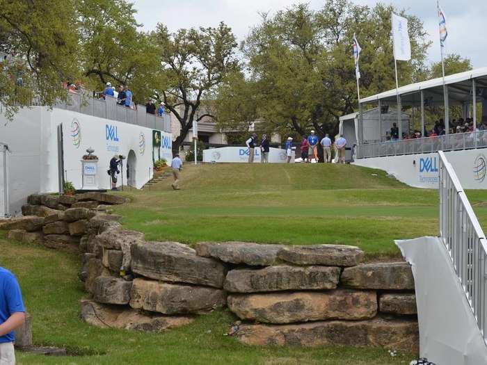 The first tee is cool, elevated above the crowd, and bordered with large rocks.