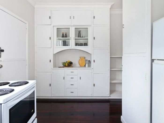 The kitchen features timber floors.