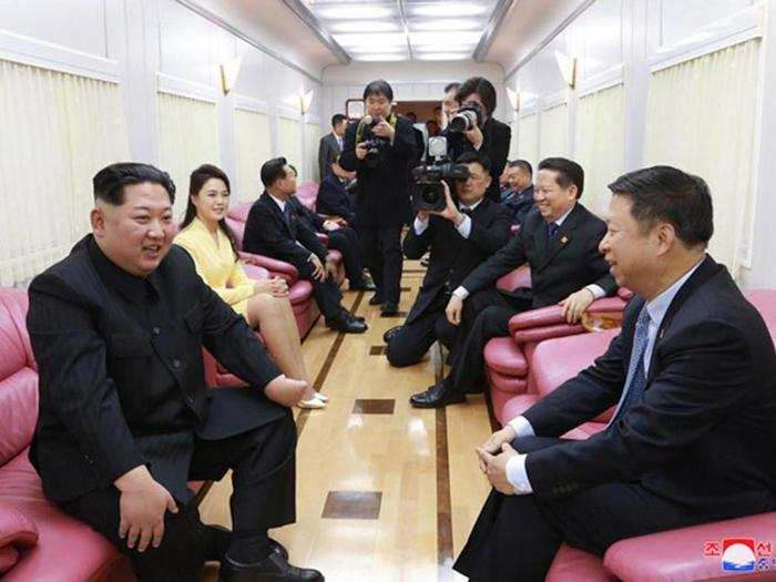 Inside one of the carriages are pink leather chairs with small wooden tables in between. Here