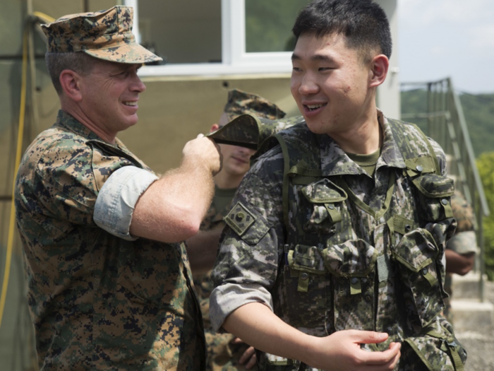 A US Marine examines a South Korean translator