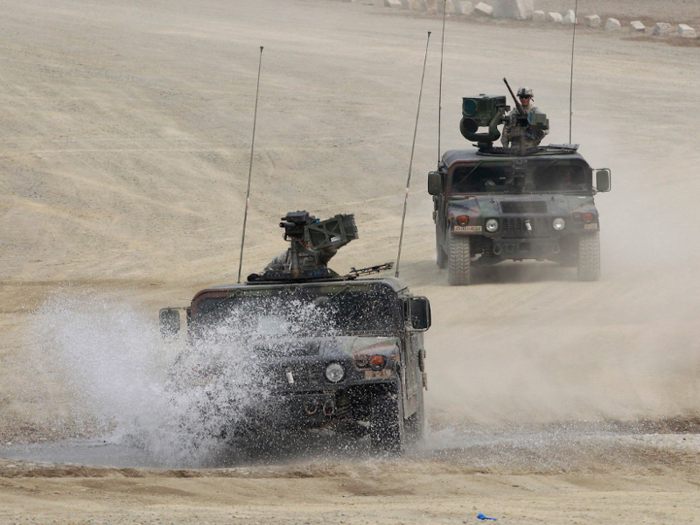 US Army Humvees move out after a live firing drill at the Rodriguez Range in Pocheon, South Korea, April 11, 2014.