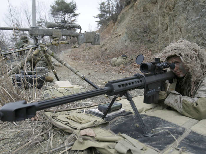 A US Marine aims his weapon at the US Army