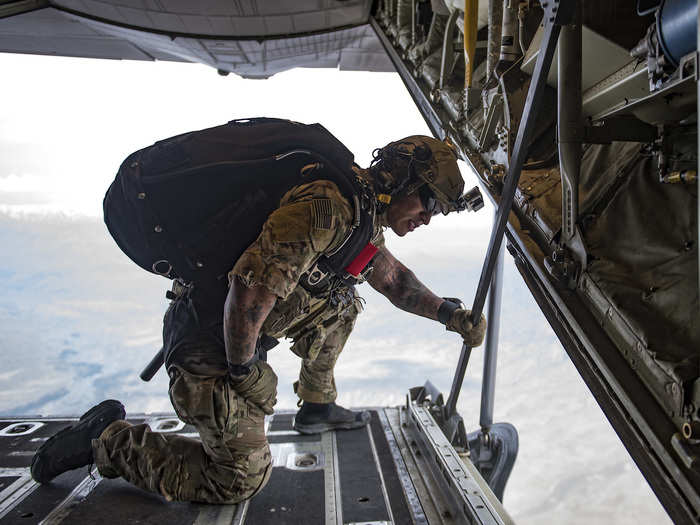 Before they jump, a pararescueman jumpmaster monitors the drop zone.