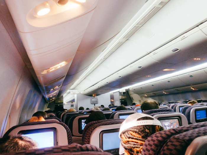 With about an hour left before arrival, the cabin lights came on and everyone started to shake themselves awake. The flight attendants came by with a final meal service.