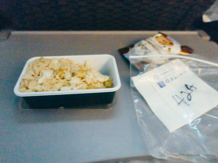 Meal two came next. The gluten-free chocolate chip cookie was actually pretty good. The dry tasteless rice with bits of chicken was not. My seat-mates