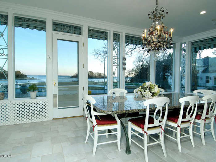 An enclosed porch provides indoor/outdoor dining space.