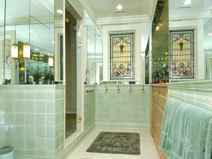 Stain glass windows are part of the built-in bathroom decor.