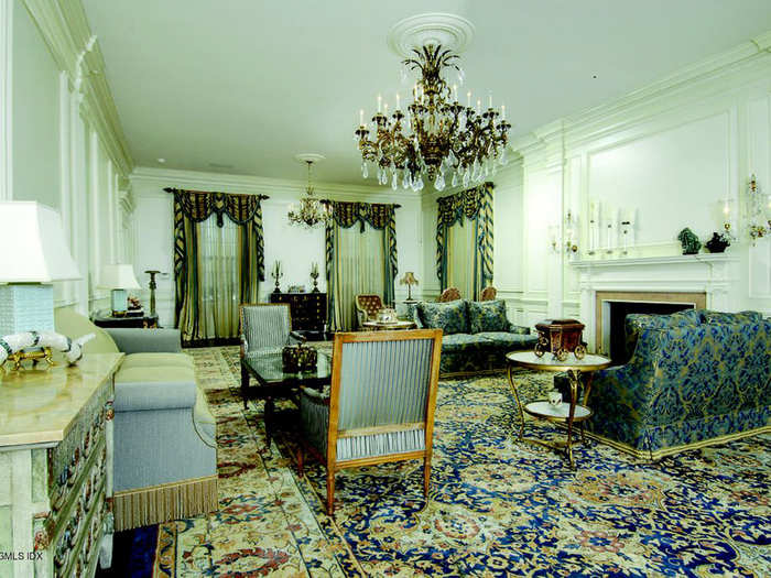 Chandeliers and elaborate mantels adorn the sitting room.