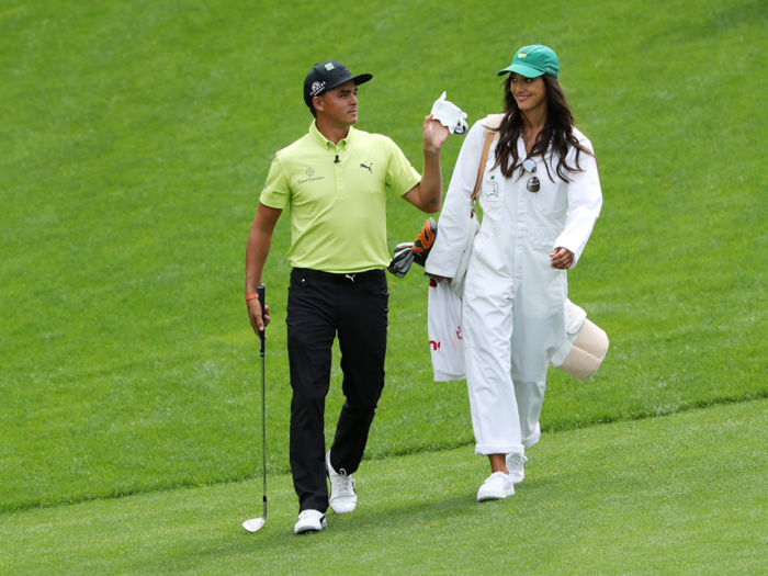 Once famously single, Rickie Fowler now has a partner to share the Par 3 contest with, walking the course with his girlfriend Allison Stokke.