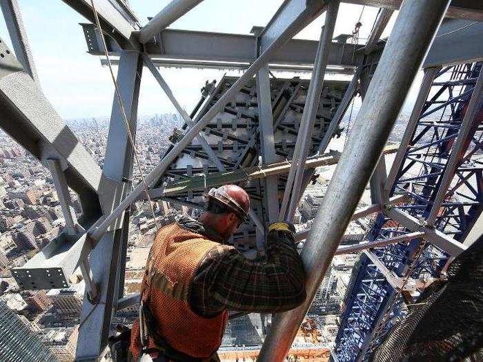 A construction crew is bolting the pieces together, anchoring the 7,500-square-foot deck to the east and south sides of the building.