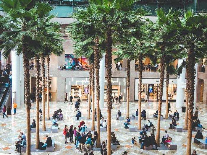 The 10-story atrium has a grove of palm trees in the center, with benches and tables for shoppers to sit and relax.