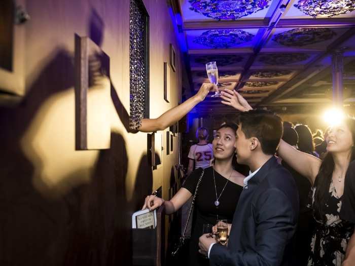 The wall along the banquet hall was creatively redone with windows and curtains that added a mischievous character to the event. A mustachioed dilettante might pop out with a set of binoculars or a disembodied hand might hand you a glass of champagne.